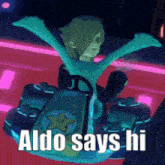 aldo says hi while riding a go kart with his arms outstretched