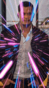 a man in a black jacket is surrounded by purple lights