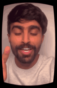 a man with a beard is making a funny face