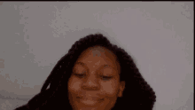 a close up of a woman 's face with a white background