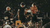 a group of people standing on a stage in front of a crowd with the letter d visible