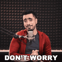 a man singing into a microphone with the words " do n't worry " written below him
