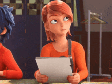 a girl with red hair is holding a piece of paper in her hands