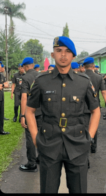 a man in a military uniform stands in front of a group of soldiers wearing blue berets