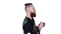 a man with a beard and a top knot is holding a ball in his hand .
