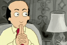 a man in a yellow shirt and red tie is making a funny face