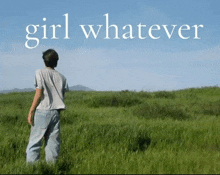 a man standing in a grassy field with the words girl whatever written above him
