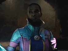 a woman in a purple and blue costume is holding a sword and looking at the camera