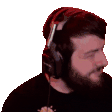 a man with a beard is wearing headphones and looking to the side .