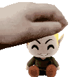a hand is holding a stuffed toy on top of a stuffed toy .