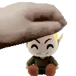 a hand is holding a stuffed toy on top of a stuffed toy .