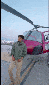 a man standing in front of a pink helicopter with the letters viggle.ai on the bottom