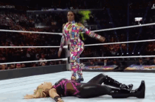 a woman laying on the ground in a wrestling ring with the word slam on the bottom right