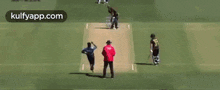 a cricket game is being played on a field with a player wearing a number 23 jersey