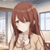 a girl with long red hair and brown eyes is standing in a room .