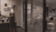 a blurred image of a woman standing in an office