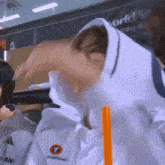 a person wearing a white hoodie with the word station on the back