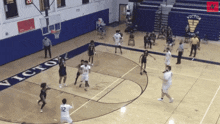 a basketball game is being played in a gym with the word victory on the wall