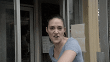 a woman is making a funny face in front of a store