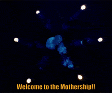 a group of people in a circle with the words welcome to the mothership on the bottom