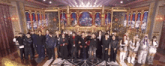 a group of people are posing for a picture in front of a large stage