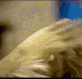 a blurry picture of a person 's face and hands
