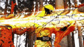 a man in a yellow helmet is standing in a forest surrounded by trees