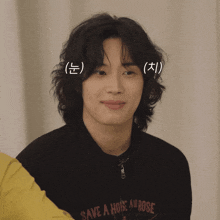 a man wearing a black sweatshirt that says save a hole and rose