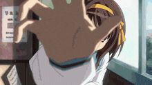 a girl in a white shirt with a yellow ribbon in her hair reaches out her hand