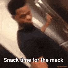 a blurry picture of a man with the words snack time for the mack at the bottom