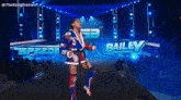 a wrestler named bailey is standing on a stage in front of a sign that says speed