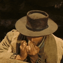 a man wearing a cowboy hat and a jacket with the number 13 on it