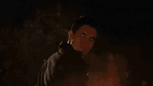 a group of fireballs are flying through the air in a dark sky .