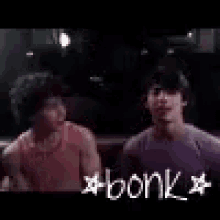 a couple of men standing next to each other in a boxing ring with the word bonk written on the bottom .