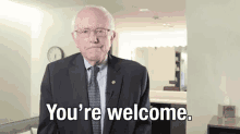 a man in a suit and tie says you 're welcome .