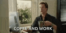 a man is sitting in front of a computer drinking coffee and work .
