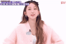 a girl wearing a pink jacket has a sign that says statv