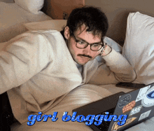 a man laying on a bed looking at a laptop with the words girl blogging below him