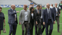 a group of people are walking on a field with a sign that says respect