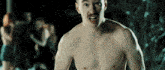 a shirtless man with a mustache stands in front of a group of women