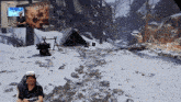 a man wearing a helmet is playing a video game with a sign behind him that says behemot