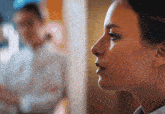 a close up of a woman 's face looking at herself in a mirror