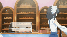 a girl in a maid costume is standing in front of a bakery counter