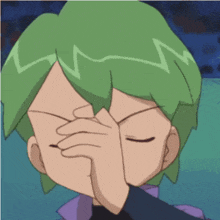 a person with green hair covering their face with their hand