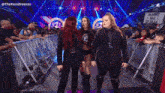 three women are standing in a ring with a sign that says make me giulia on it