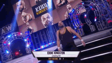 a wrestler named eddie kingston is standing in front of a sign that says aew