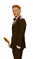 a man in a tuxedo holds up a sign that says 10