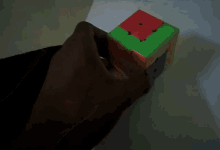 a person is playing with a colorful cube that has a square in the middle