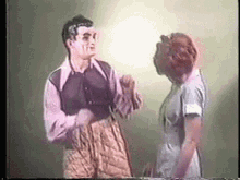 a man and a woman are standing next to each other .