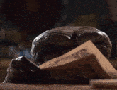 a statue of a monster reading a newspaper